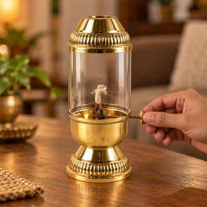 Brass akhand diya lit with glass chimney